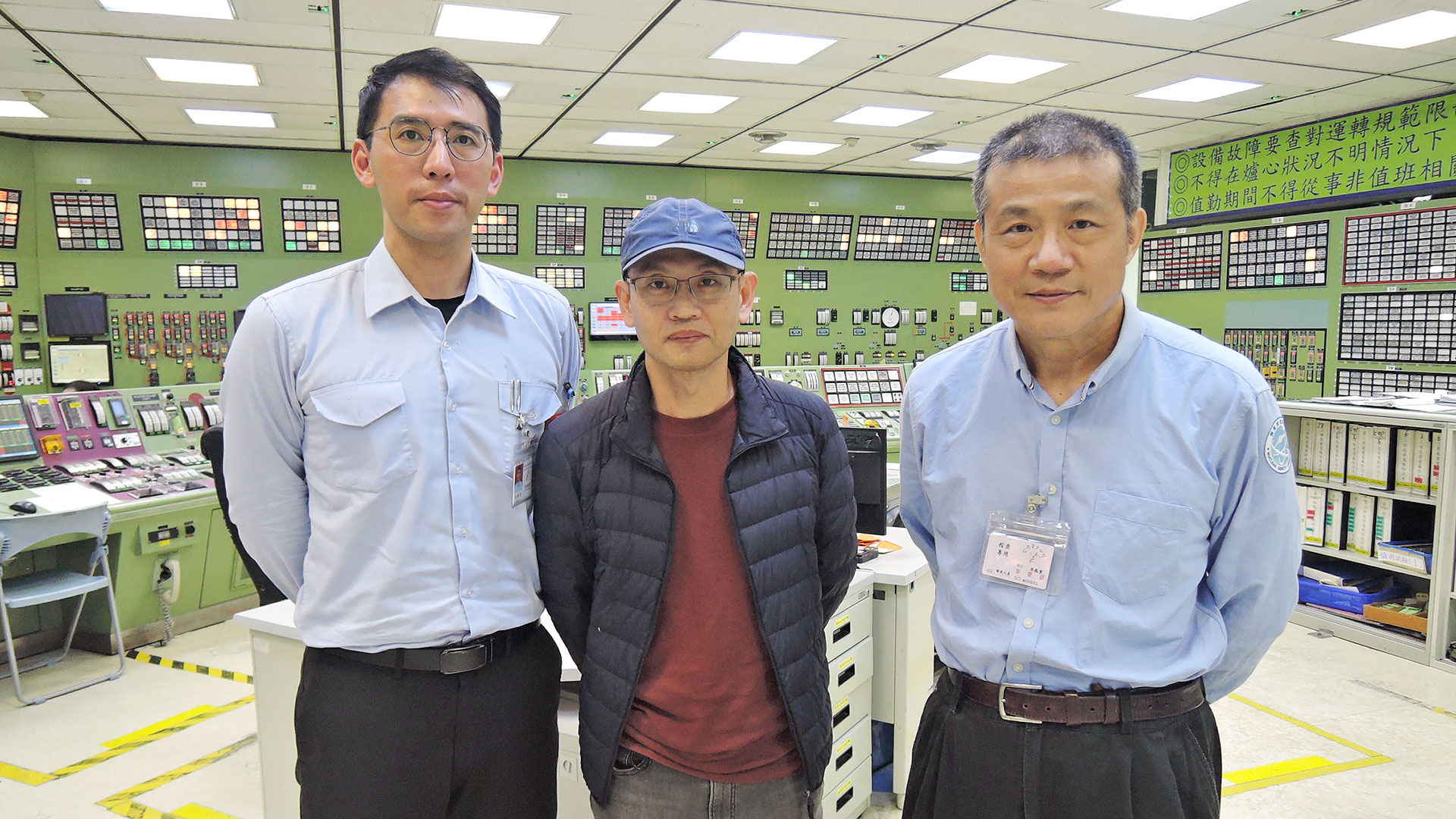 核安會吳簡任技正(右)及恆春鎮公所劉里幹事(中)於1號機主控制室了解機組狀況(圖左為核三廠值班經理)